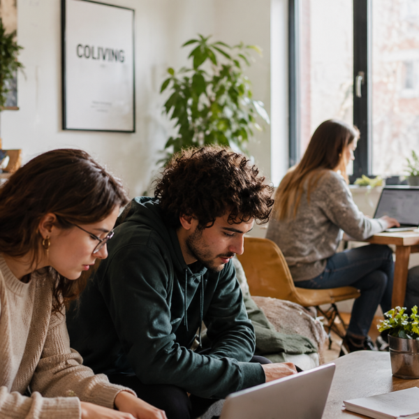 People working together in a modern coliving workspace environment